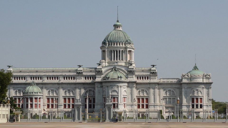 La salle du trône Ananta Samakhom, à Dusit : un édifice de marbre de style néo-Renaissance dessiné par des architectes italiens, avec son grand dôme central et ses coupoles de cuivre vert-de-grisé. — © Eric Monteil Grand édifice néo-Renaissance en marbre blanc coiffé d'un dôme central vert, précédé d'une vaste esplanade pavée et d'une grille.